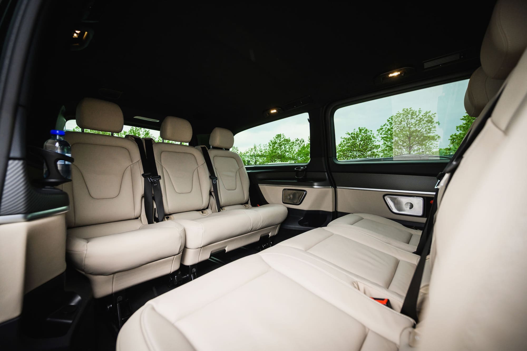 Interior of an AYDEN Mercedes-Benz V-Class with light leather seats for up to six passengers