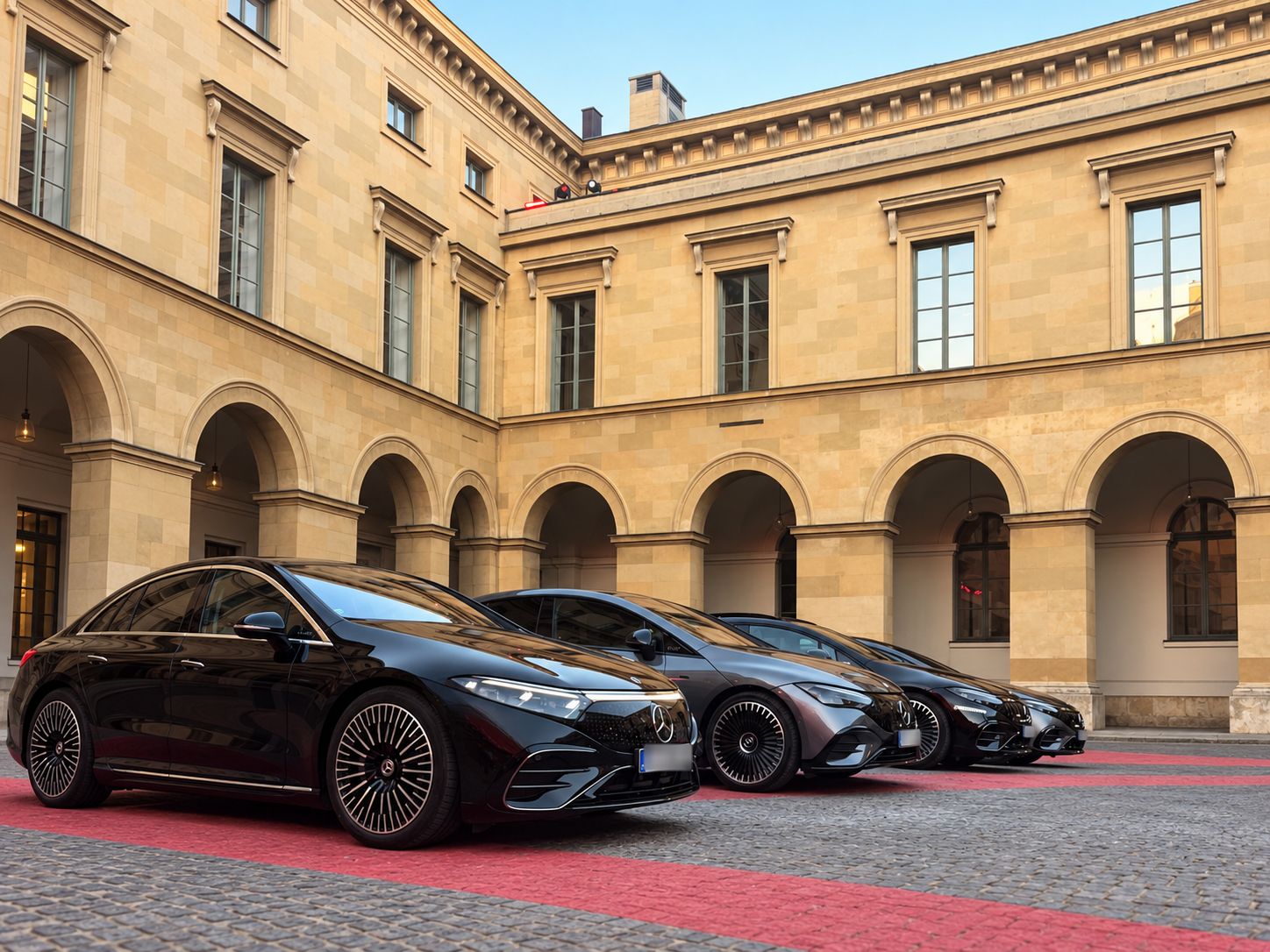 AYDEN event shuttle: black Mercedes-Benz saloons lined up in the courtyard of an event venue, ready for the guests