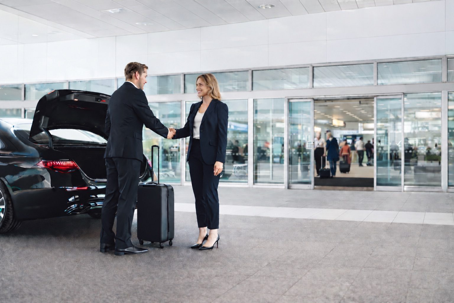 Chauffeur greeting a traveller in the airport arrivals hall