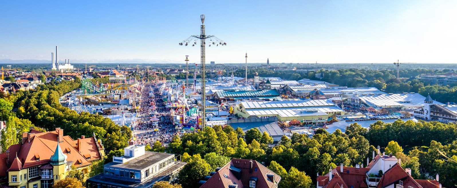 View over Oktoberfest on the Theresienwiese in Munich with beer tents, swing carousel and the main festival street